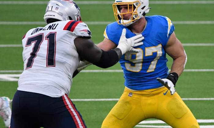 Chargers LB Joey Bosa (97) and Patriots OL Michael Onwenu (71)